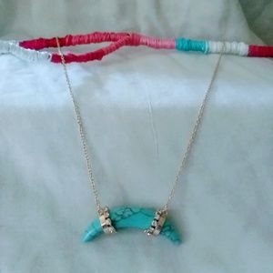 Turquoise horn with gold colored accents